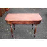 An early Victorian mahogany side table, raised on turned legs, 73cm high,