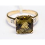 A smoky olive quartz dress ring, cushion cut checkerboard top, with four round cut diamonds,