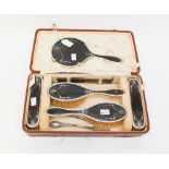 A George V silver mounted and tortoiseshell dressing table set, cased, Mappin & Webb,