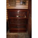 An early 20th Century mahogany stacking bookcase, of three tier form, each tier graduated in size,