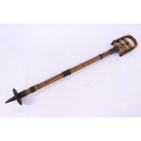 A vintage bamboo and brass shooting stick