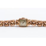 A ladies 14ct rose gold 'Mido' bracelet watch, with a square champagne dial,