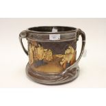 A very large Bretby pottery loving cup, decorated with Oriental scenes all around,