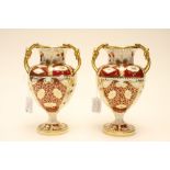 A pair of Davenport red Imari pedestal vases, Campana form with knotted rope handles,