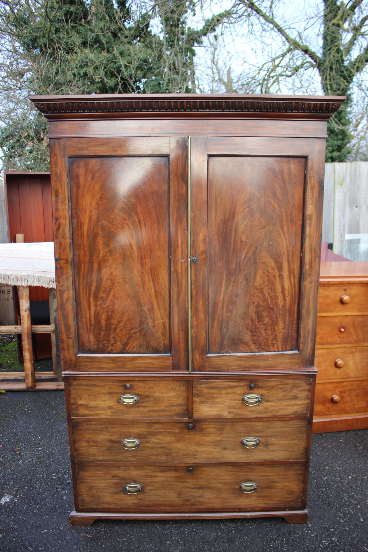 An early Victorian mahogany linen press, the top with a plain cornice, two doors,
