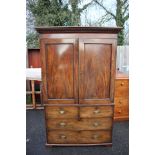 An early Victorian mahogany linen press, the top with a plain cornice, two doors,