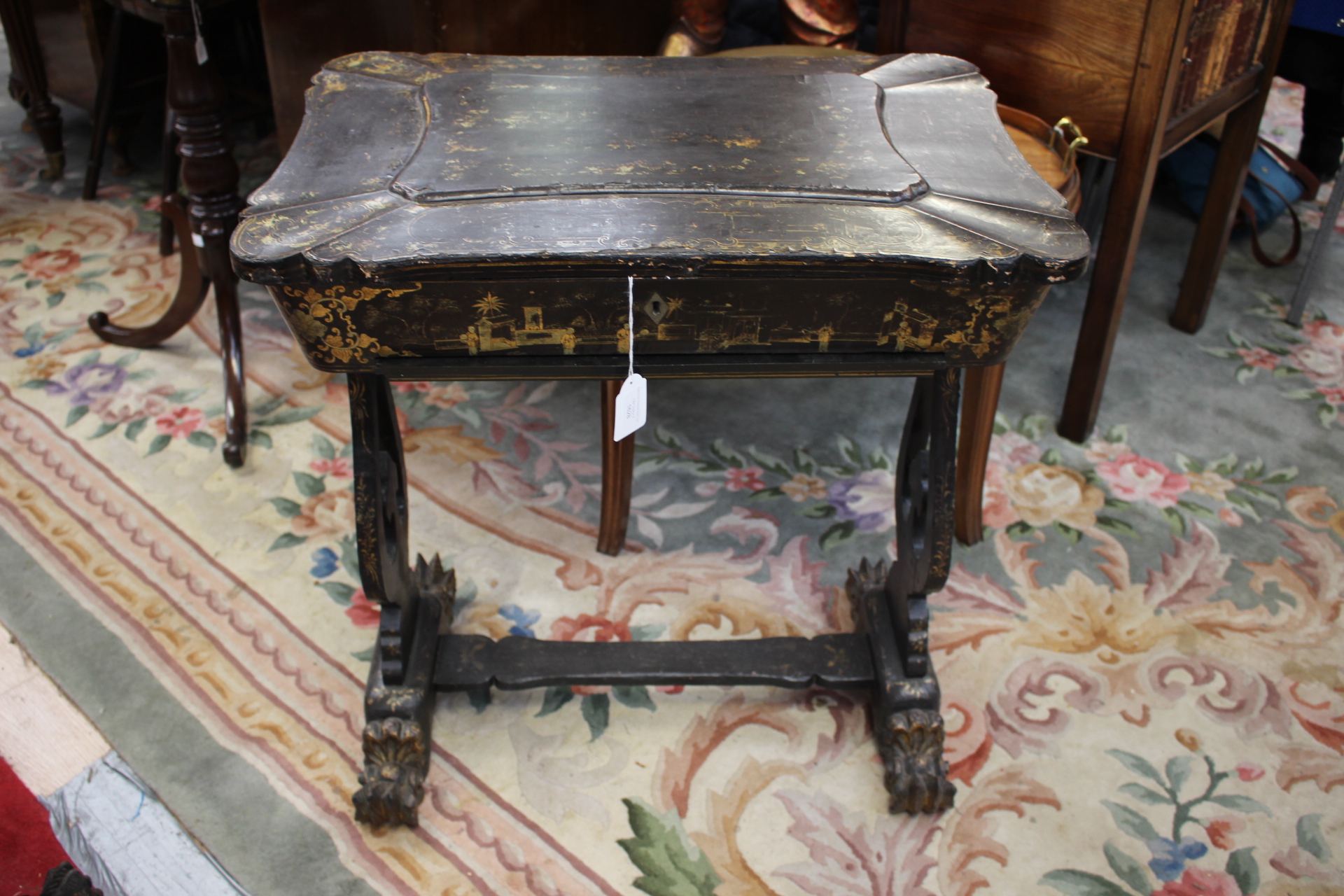 A late 19th Century Chinese export lacquered work table, circa 1880, sarcophagus hinged top,