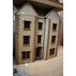 A very large wooden dolls house, in the form of a Georgian town house,