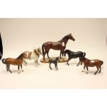 A collection of Beswick horses, including a light grey Shire Horse, a Hunter on wooden base,