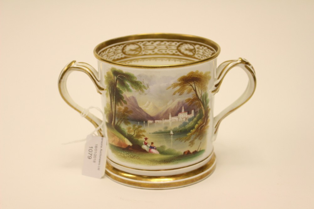 An early 19th Century porcelain loving cup, hand painted with landscape and inscribed, 'Mr Philip H.