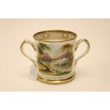 An early 19th Century porcelain loving cup, hand painted with landscape and inscribed, 'Mr Philip H.