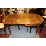 An early 19th Century mahogany extending dining table, fitted with an extra leaf,