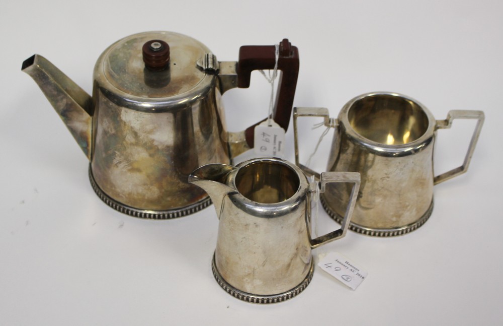 A silver Walker and Hall three part tea service, Sheffield, the teapot inscribed and dated 1942,