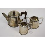 A silver Walker and Hall three part tea service, Sheffield, the teapot inscribed and dated 1942,