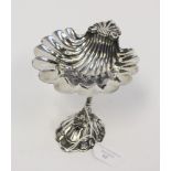 A silver plate Victorian style bon bon dish, shell bowl above Dolphin support on stylised wave base,