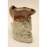A salt glaze stoneware character jug pitcher, modelled as the face of Mr Punch,