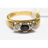 A sapphire and diamond three stone ring, set in 18ct gold,