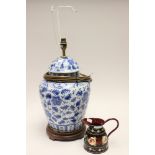 A blue and white Oriental style table lamp with wooden plinth,