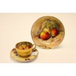 A Royal Worcester fruit painted tea trio, 1924, painted by Ricketts and Austin, including cup,