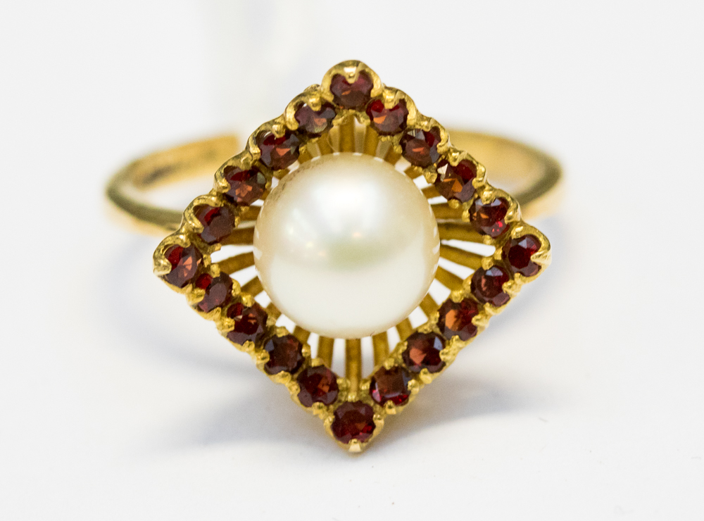 A yellow metal, tested 18ct, pearl and garnet dress ring,