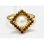 A yellow metal, tested 18ct, pearl and garnet dress ring,