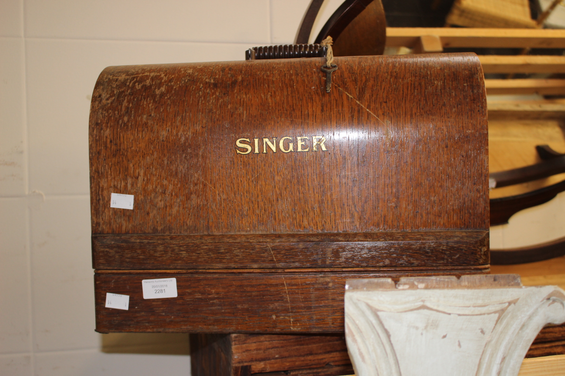 An early 20th Century oak cased Singer sewing machine