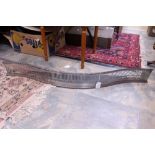 A 19th Century steel serpentine fireside fender, bar pierced frieze,