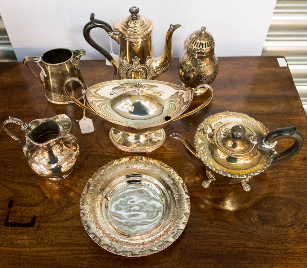 A group of silver plated wares to include a sugar coaster, hot water pot, sauce tureen, milk jug,