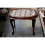 An early 20th Century woolwork panel top low table,