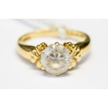 A 14ct gold single stone ring, claw set with a white stone,