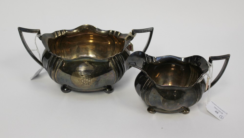 A silver monogrammed, twin handled sucrier, Sheffield 1905 with matching jug, approx weight 17.