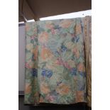 Two pairs of green base curtains printed with a modern floral pattern in an array of pastel colours,