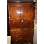 A George III mahogany linen press, two doors, two dummy drawers and two long drawers,