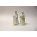 A pair of Derby porcelain candle snuffers, modelled as a monk and a caped woman, on bases,