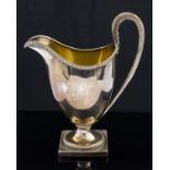 A George III silver cream jug, Neoclassical helmet form, reeded acanthus handle and beaded borders,