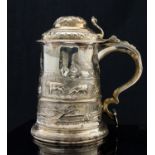 A George II silver lidded tankard, cylindrical form with domed lid and cast foliate thumb piece,