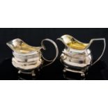 Two George III silver cream jugs, Neoclassical helmet form, on ball feet,