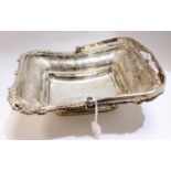 A George III silver bread basket, swing handled rectangular form with chased foliate border,