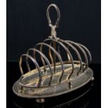 A Victorian silver toast rack, six section, beaded frame on an integrated bright cut oval tray,