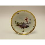 A Chelsea saucer, circa 1765, river landscape with insects within a foliate gilt border,