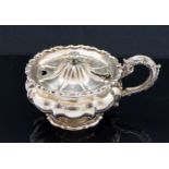 A George IV silver melon form mustard pot, squat ovoid footed form, lobed,