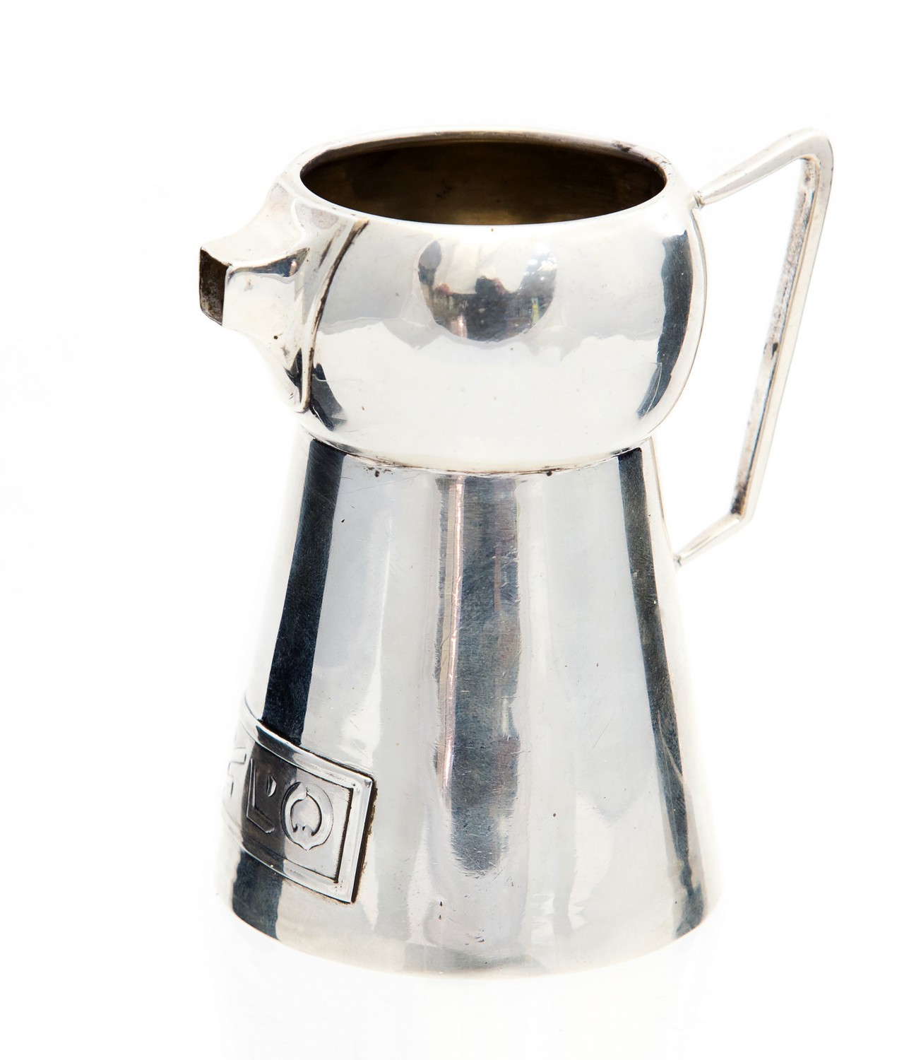 An Arts and Crafts silver jug, lobed conical form with angled handle and pinched square spout,