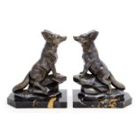 A pair of large French Art Deco spelter bookend modelled on Phoenix on rocks,