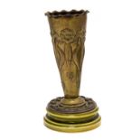 An Arts & Crafts repousse brass vase in the Art Nouveau style, decorated with stylised daisies,