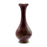 Bernard Moore, a speckled sang de boeuf vase, baluster form with elongated neck and flared rim,