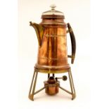 A Bing secessionist copper percolator on a burner stand