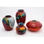 A collection of four Poole Pottery vases, including orange Delphis vase, squat ovoid form,