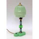An Art Deco green glass table lamp, the tricoloured glass support, rising from green moulded base,