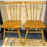 A pair of Ercol light elm and beech stick back chairs,