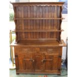 Rupert Griffiths, Arts and Crafts Cotswold style carved oak dresser and rack, pegged construction,